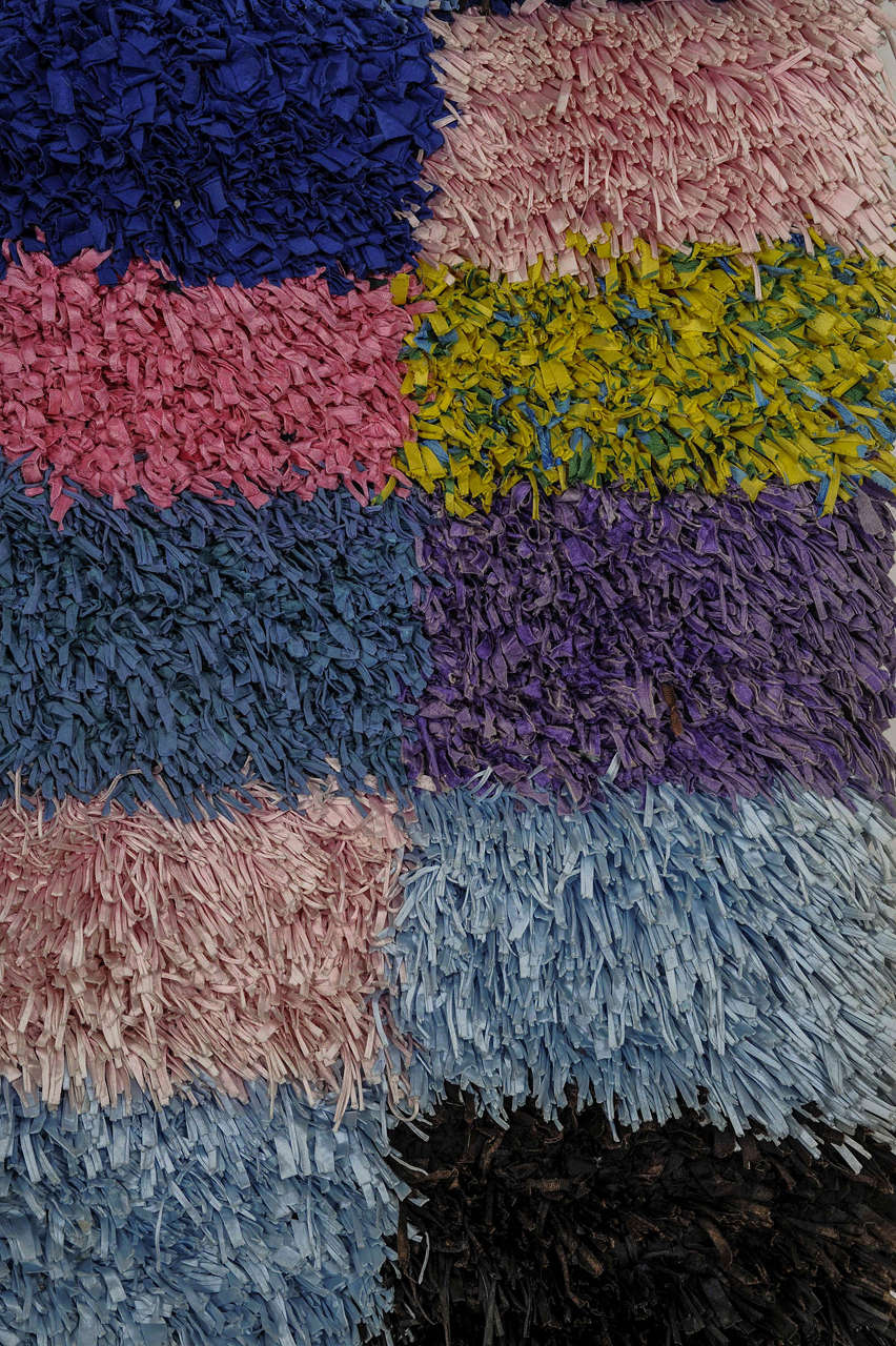 Woven with the exclusive use of recycled yarns of various type, ranging from cotton to lurex, this represents 'art brut' within the domain of the textile arts. Weavings such as this are the product of illiterate Berber people living at the margins